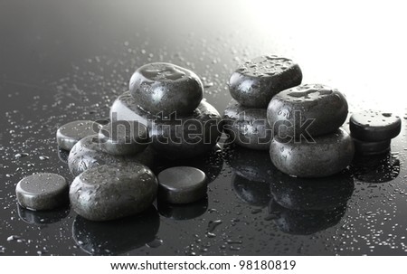 Spa stones with drops on grey background
