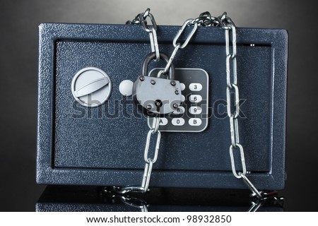 safe with chain and lock on grey background
