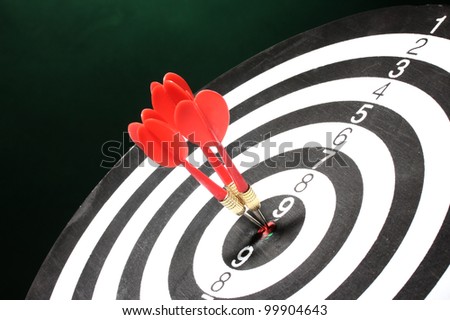 dart board with darts on green background