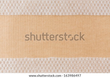Cardboard background with bubble wrap stripes