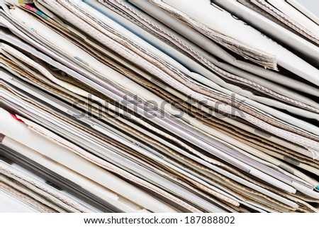 Closeup texture of diagonal newspapers stack. Abstract background. Breaking news, journalism, power of the media, newspaper and magazine ads and subscription concept.