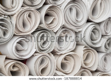 Rolls of newspapers, closeup shot. Breaking news, journalism, power of the media, newspaper and magazine ads and subscription concept. Great as a web page banner, article illustration and more.