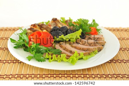 Meat, cut into slices beautifully decorated with lettuce and tomato.