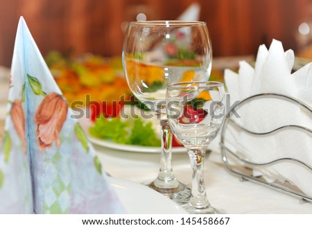 Wine glass and glass on the background of elegant table.