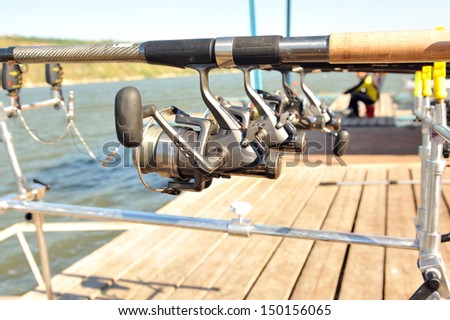 Reels with rods while fishing on  sunny day.