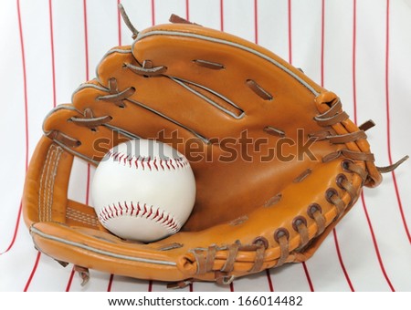 Baseball ball in a trap on a light striped background.