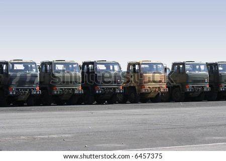 A collection of trucks with one standing out, symbolizing being different from the crowd