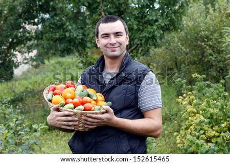 smiling farmer holding vegetables basket