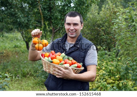 smiling farmer holding vegetables basket
