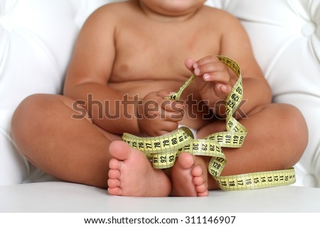 Adorable Baby Boy with a measuring tape