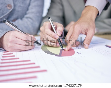 business people reviewing sales performance in a meeting.