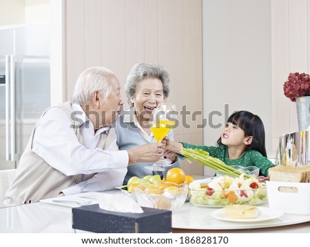 granddaughter toasting with grandma and grandpa