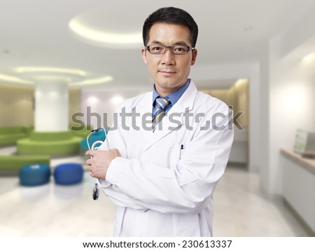portrait of a male asian doctor in hospital lobby.