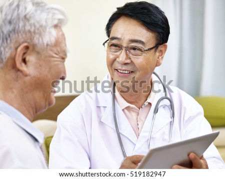 asian doctor talking to a senior patient, happy and smiling
