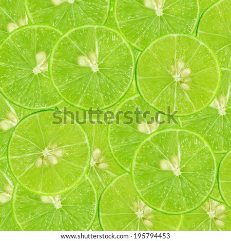 background of heap fresh green lime slices. Seamless pattern for your design. Close-up. Studio photography.