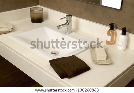 Basin with soap and towels in a bathroom