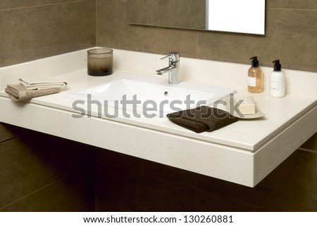 Basin with soap and towels in a bathroom