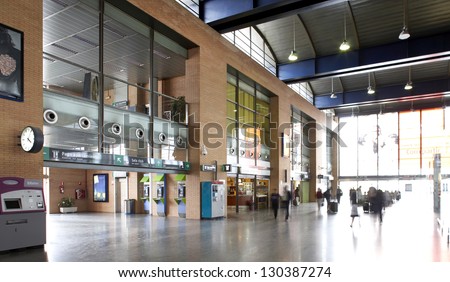 Railway station entrance with people and ticket machine