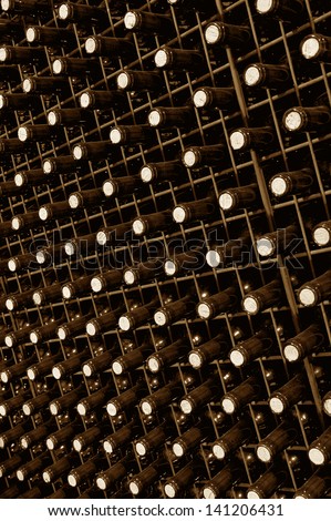 Large group of wine bottles in perspective at spanish cellar bi tone vertical