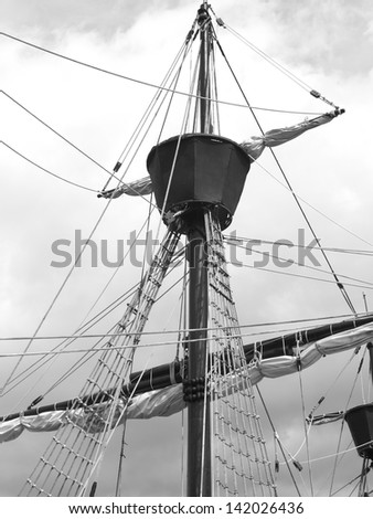 Historical style sail boat on a classic tall ship black and white vertical