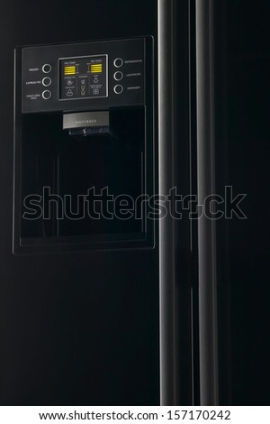 Modern black refrigerator with frontal display control panel low key