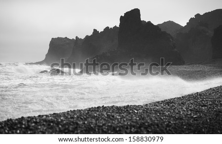 Sea coast volcanic rocks and black beach sand at Snaefellnes Peninsula Iceland black and white