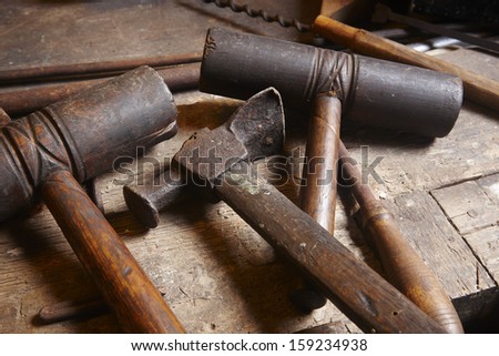 Antique Hammers and tools with wood pieces.