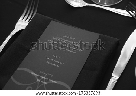 Restaurant menu on table for guests black and white