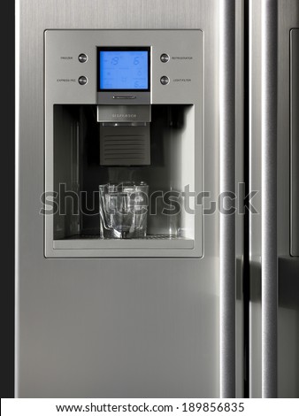 Fridge detail with ice dispenser and glass. Vertical