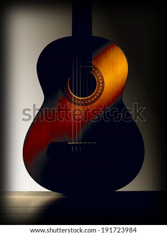 Spanish classic guitar with grey background. Vertical