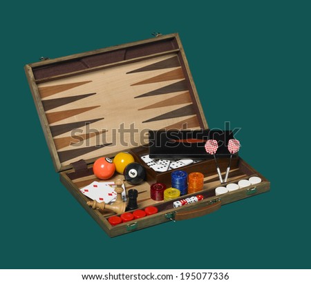 Board games in a wooden box isolated on green. Horizontal