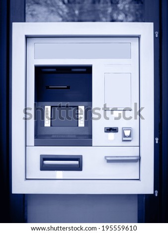 Automated teller machine in blue tone. Vertical format