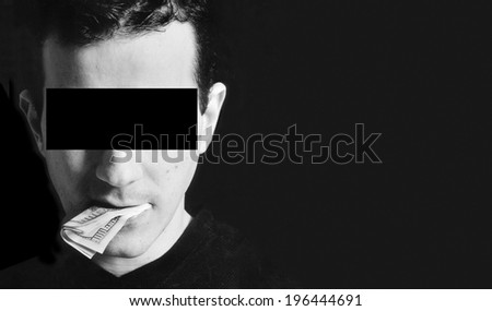 Man with a one hundred dollar bill in the mouth. Blanked eyes