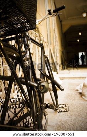 Locked bike in a corridor. Sepia tone. Vertical format