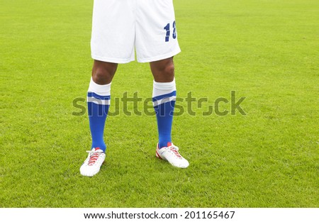 Football player dressed in white and blue in the ground