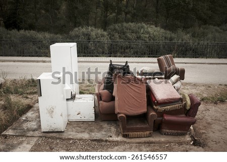 Abandoned furniture and fridges in the street and forest. Horizontal
