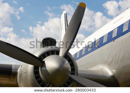 Old aircraft propeller and airframe with blue sky background. Horizontal