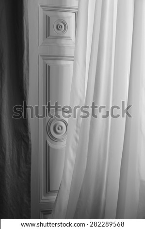 White curtain and wooden window door in black and white. Vertical