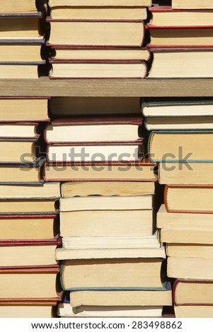 Old books staked on a case. Vertical