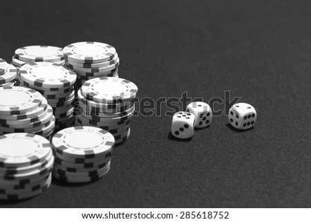 Crabs and betting chips in a table game. Black and white