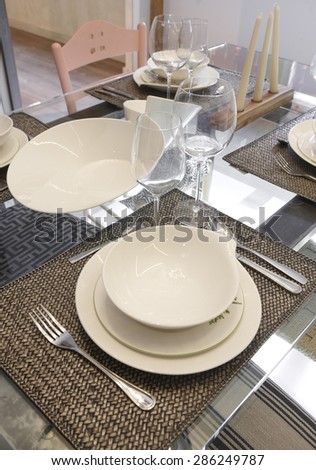 Crockery set over a table ready to be served. Vertical