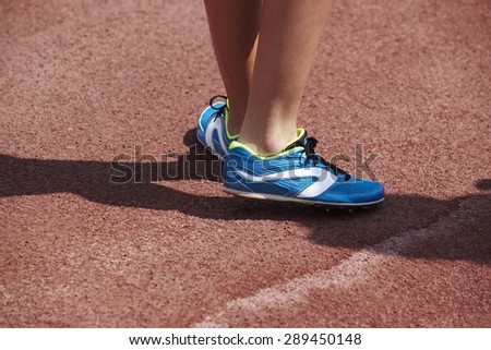 Jumping sport shoes in the athletic field ground. Horizontal