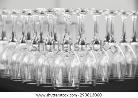Empty cups of wine on a table in black white. Horizontal