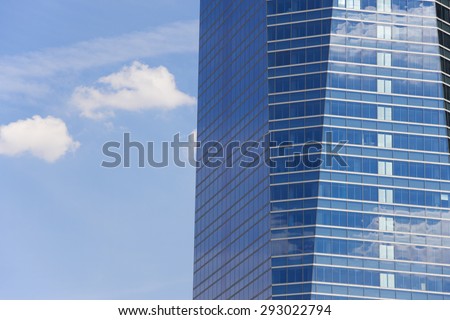 Modern metallic and glass building facade in blue tone. Horizontal