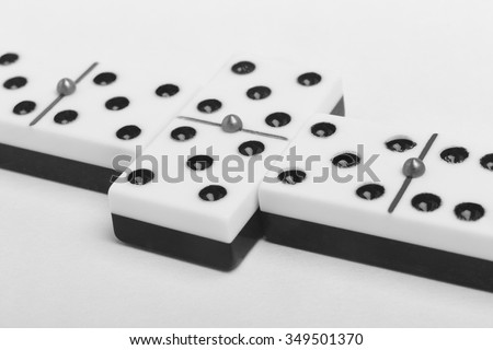 Domino game with pieces over a white background. Black, white. Detail