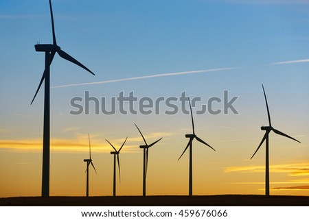 Wind turbines at sunset. Clean alternative renewable energy. Horizontal