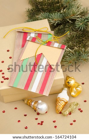 Christmas decoration with toys gifts and festive packaging and spruce branch in the background