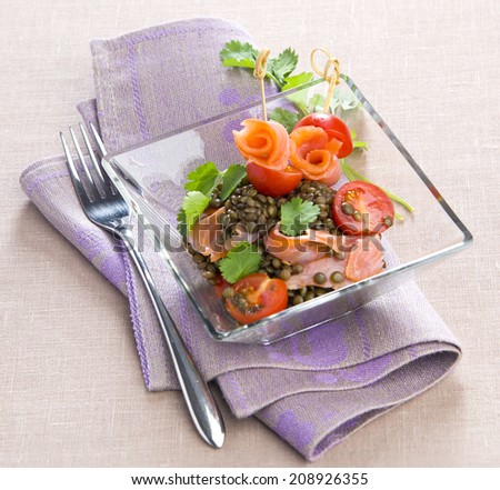 lentil salad with salmon fillet with cherry tomatoes in a glass salad bowl cilantro