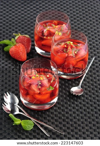 strawberry wine with mint in glass cups on a black background