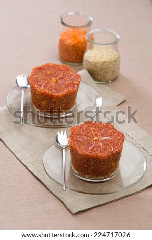 flan red lentils with quinoa on a glass saucer with red quinoa and lentils in a glass jar